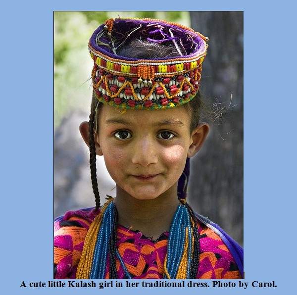 Kalash Photos, Images; A cute little Kalash girl in her traditional dress - Kalash Valleys Pictures, Chitral Kalasha Pics, Images: A cute little smiling Kalash girl in her traditional dress - Kalash Valleys of Chitral Photos