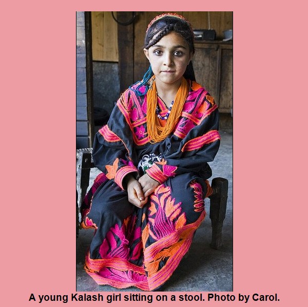 Kalash Photos, Images; A young Kalash girl sitting on a stool - Kalash Valleys Pictures, Chitral Images & Pictures of Kalasha People- A young Kalash girl sitting on a stool - Photos of Kalash Valleys of Chitral