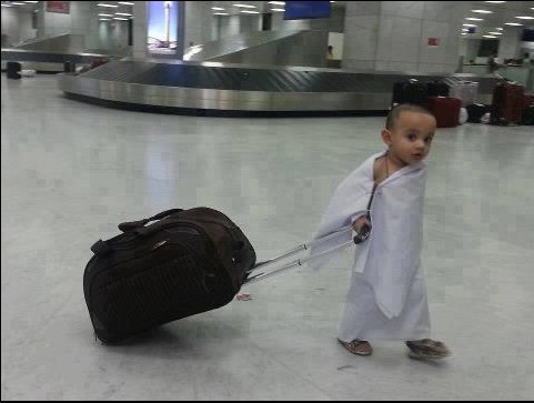 Photo of a Cute Little Haji, carrying his bag at the Airport.