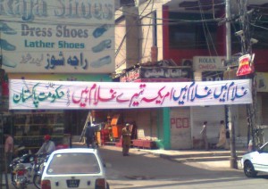 Funny Pre Election Posters and Banners: A banner in a street proclaiming that we are slaves of America - Pakistan Elections 2013
