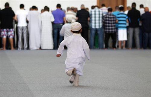 Namaz (Salat) Pictures - A little boy is running in a mosque to join the Namaz - Namaz Photos