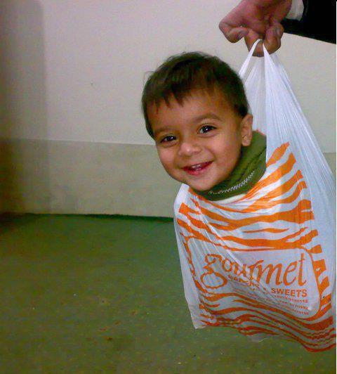 Pakistani Funny Pictures : Baby in Gourmet Sweets shopping bag - Funny Photos