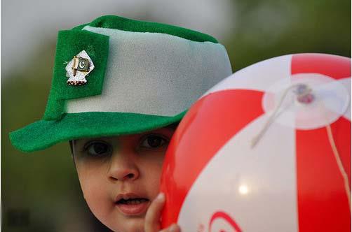 Pakistan Flag Lovers - A little boy with a Pakistani flag on his cap - Proud Display of Pakistani flag Proud Display of Pakistani Flag - A cute little boy with a Pakistani flag on his cap and holding a very big ball - Pakistani Flag Lovers