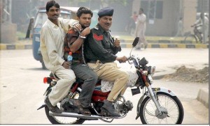 Pakistanis need to be trained: Pakistani Policeman breaking law, three men riding on a motor cycle - Pakistanis need to be Disciplined