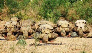 Namaz (Salat) Pictures - Pakistani soldiers offering Namaz in full battle dress while their rifles and helmets are near by - Namaz Photos